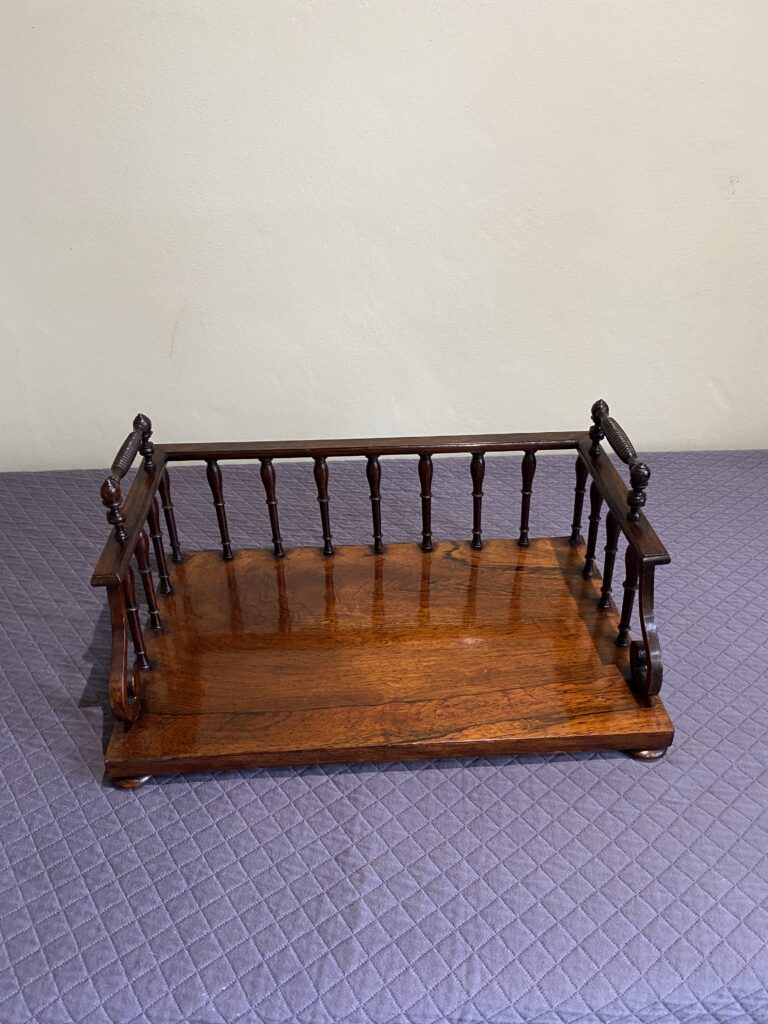 Regency Rosewood Book rack with finely turned spindles and handles, set on rosewood turned bun feet.