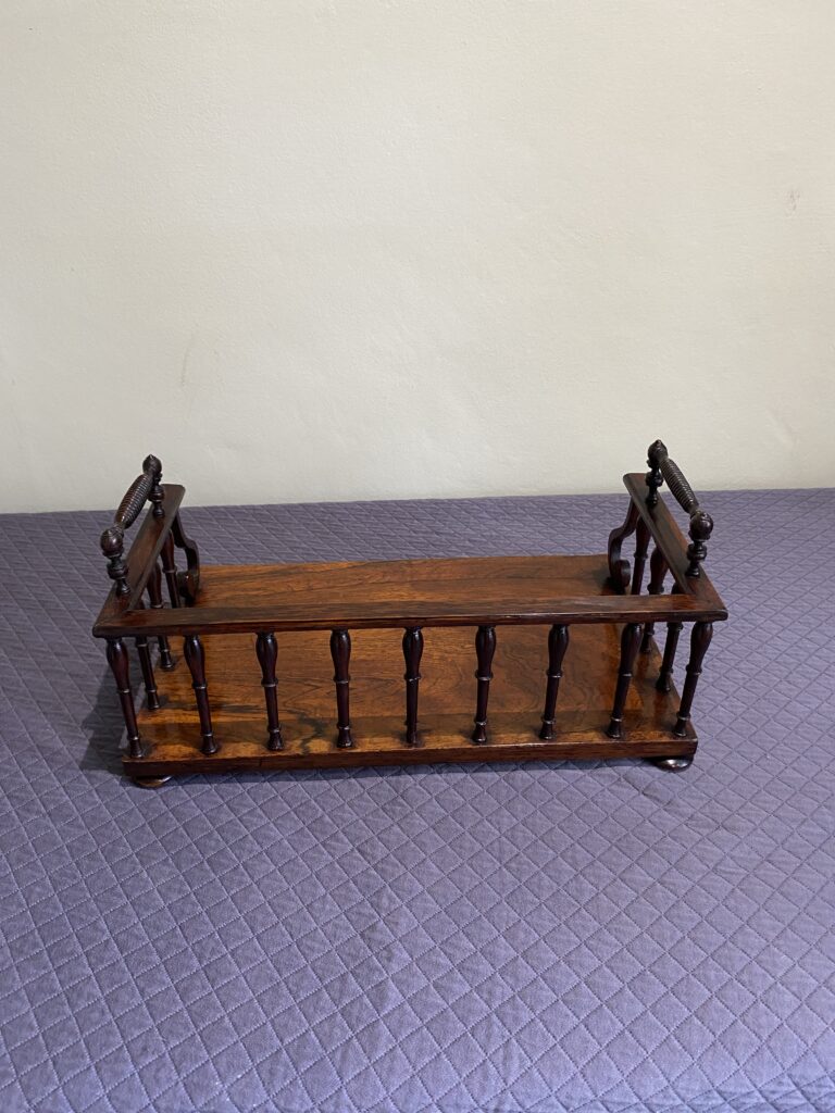 Regency Rosewood Book rack with finely turned spindles and handles, set on rosewood turned bun feet.