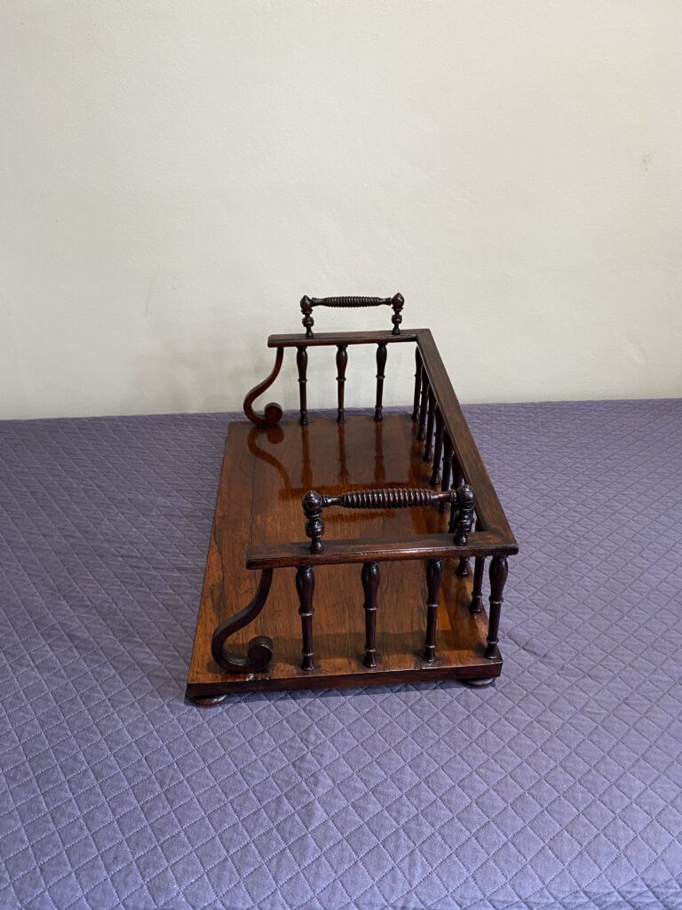 Regency Rosewood Book rack with finely turned spindles and handles, set on rosewood turned bun feet.