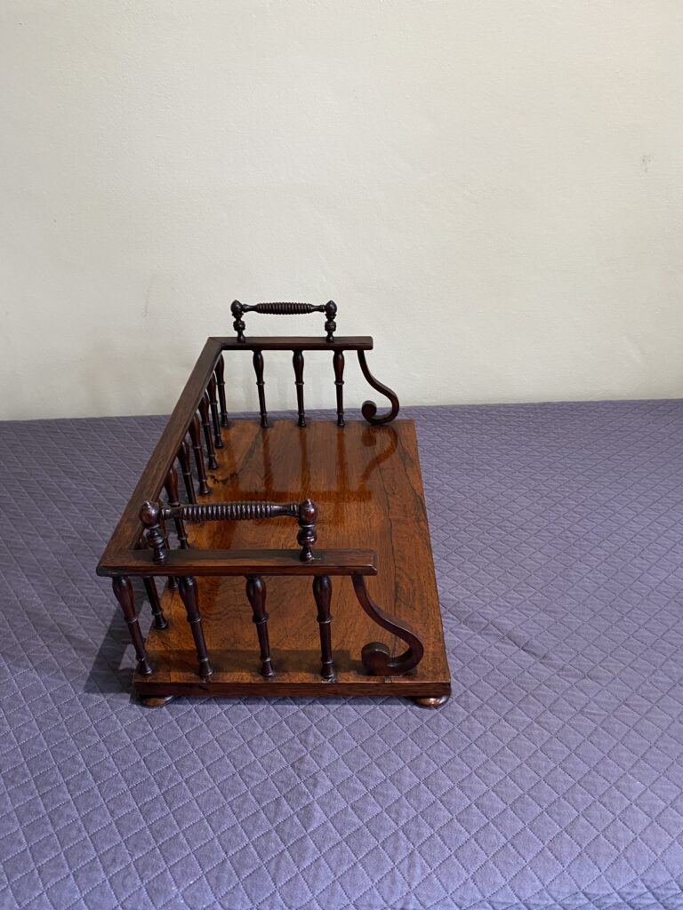 Regency Rosewood Book rack with finely turned spindles and handles, set on rosewood turned bun feet.