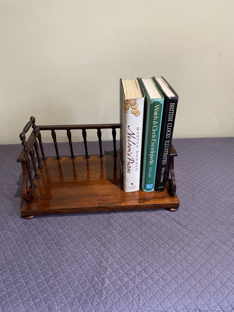 Regency Rosewood Book rack with finely turned spindles and handles, set on rosewood turned bun feet.